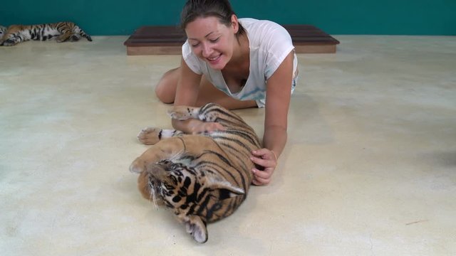 Girl playing with Tiger Cub