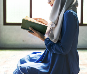 Muslim woman reading from the quran