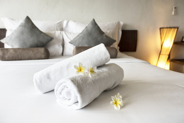 Fototapeta na wymiar Rolled up clean towels on a bed