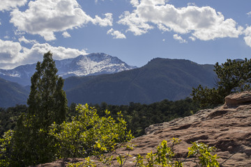 Rocky Mountain peaks with forest and snow