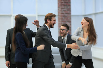 Portrait of an enthusiastic business team congratulating their c