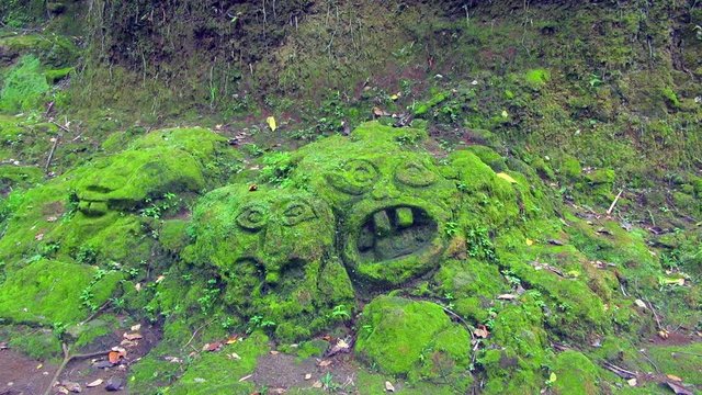 Moss-Covered Rock Sculpture On The Bali Grounds