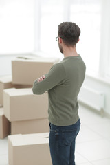 rear view.a man looks at boxes of stuff.