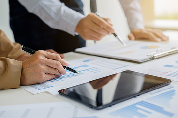 Business concept. Business people discussing the charts and graphs showing the results of their successful teamwork.