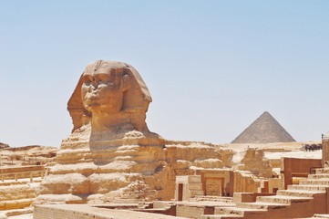 The Sphinx and pyramids on a cloudless day. Giza, Egypt.