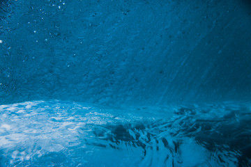 Underwater barrel wave in tropical ocean. Wave texture in sea