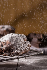 Chocolate scone with a rain of powdered sugar 