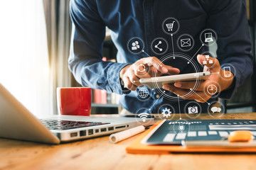  businessman hand working with laptop computer, tablet and smart phone in modern office with virtual icon diagram at modern office in morning light 