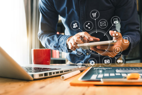  businessman hand working with laptop computer, tablet and smart phone in modern office with virtual icon diagram at modern office in morning light 