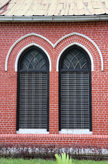 Window frame and red brick of exterior of main church at cathedral of the holy trinity, the church of the province of Myanmar.