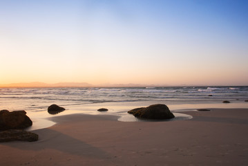 The pinky sunset on the deserted beach in Byron Bay, Australia