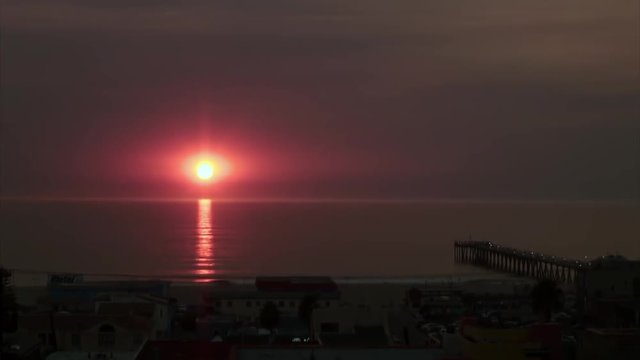 Time-Lapse: Sunset Over Shoreline with Pier