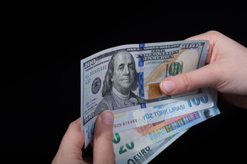 Hand holding American dollar  isolated on black background