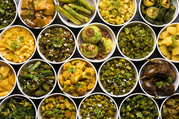 Indian sabzi / vegetable fried recipes served in white bowl over moody or colourful background. selective focus