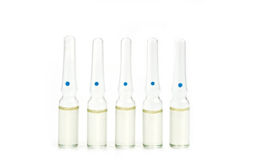 Five glass ampoules with liquid on the old background