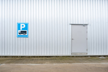 Parking lot label on metal sheet pattern and background.