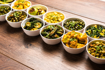 Indian sabzi / vegetable fried recipes served in white bowl over moody or colourful background. selective focus