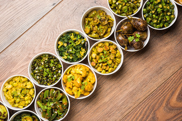 Indian sabzi / vegetable fried recipes served in white bowl over moody or colourful background. selective focus