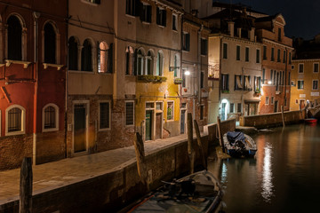 Fototapeta na wymiar Night view of canal in Venice, Italy. Architecture and landmarks of Venice. Night life of Venice. Venice postcard with night canal