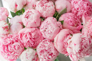 Beautiful bouquet of pink peonies . Floral composition, daylight. Wallpaper. Lovely flowers in glass vase.