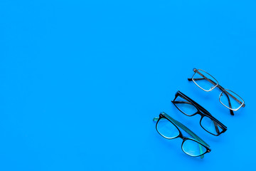 Glasses concept. Set of glasses with different eyeglass frame and transparent lenses on blue...