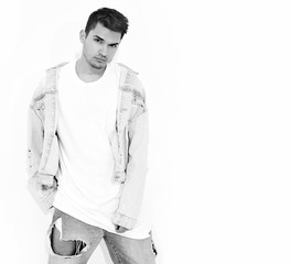 Fototapeta premium Portrait of handsome young model man dressed in jeans clothes posing on white background. Isolated