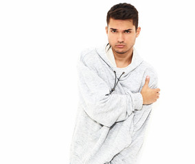 Portrait of young handsome model man dressed in gray casual hoodie clothes posing on white background. Isolated