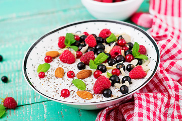 Detox and healthy superfoods breakfast in bowl. Vegan almond milk chia seeds pudding with raspberries, blackberries and  mint.