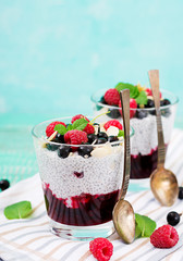 Detox and healthy superfoods breakfast in bowl. Vegan almond milk chia seeds pudding with raspberries, blackberries and  mint.