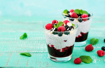 Detox and healthy superfoods breakfast in bowl. Vegan almond milk chia seeds pudding with raspberries, blackberries and  mint.