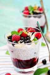 Detox and healthy superfoods breakfast in bowl. Vegan almond milk chia seeds pudding with raspberries, blackberries and  mint.