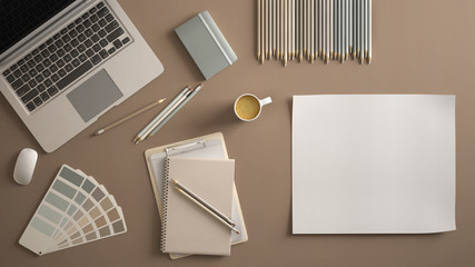 Stylish minimal office table desk. Workspace with laptop, notebook, pencils, coffee cup and sample color palette on dark beige background. Flat lay, top view, blank paper mockup template