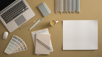 Stylish minimal office table desk. Workspace with laptop, notebook, pencils, coffee cup and sample color palette on pastel yellow background. Flat lay, top view, blank paper mockup template