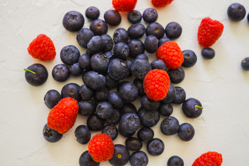 Fresh organic blueberries and raspberries on the table.