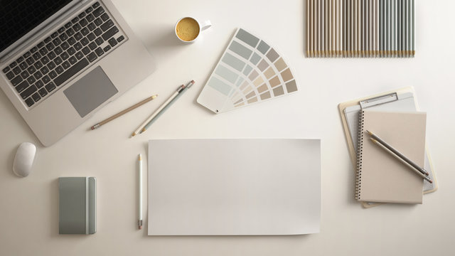 Stylish minimal office table desk. Workspace with laptop, notebook, pencils, coffee cup and sample color palette on white background. Flat lay, top view, blank paper mockup template