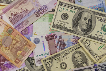 Fototapeta na wymiar Multicurrency background of the us dollars, russian rubles and ukrainian hryvnias