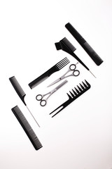 Scissors and combs for hair cut and treatment lie on a white table