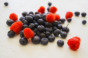 Fresh organic blueberries and raspberries on the table.