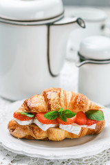 Croissant with strawberries, brie cheese or Camambert and mint. Delicious gourmet Breakfast