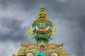 Demon Guardian with cloudy sky at Wat Phra Kaew , The Temple of Emerald Buddha in Bangkok, Thailand