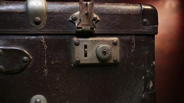 Close up on vintage brown suitcases lock.
