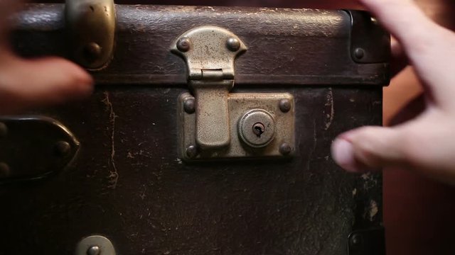 Close up on vintage brown suitcases lock.