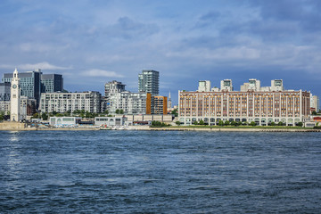 Fototapeta premium Gorgeous skyline of Montreal as seen across the St. Lawrence River on a sunny day. Montreal, Quebec, Canada.