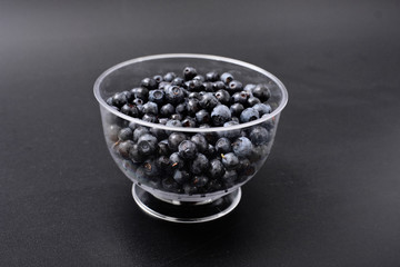 forest berry blueberry on a black background.