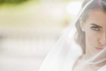 Pictures of stunning bride posing under the veil outside