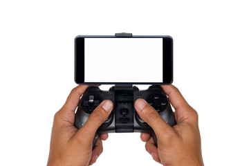 Hands of a man holding the joystick for playing games with a mobile phone isolated on white background with clipping path.