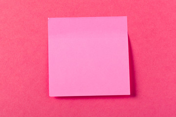 Blank paper pieces  on a colored pink background