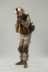 Soldier in camouflage holding rifle