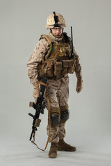 Soldier in camouflage holding rifle