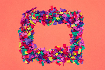 Festive party decor and confetti on pink background